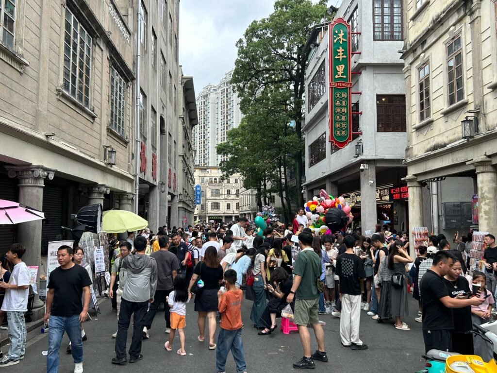 Tourists and locals shopping in a busy marketplace in Shantou City